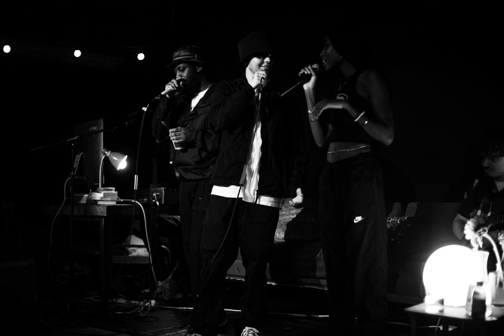 Franklin Armstrong, Dylan Gray and Jaydonclover performing on stage. Black and white.